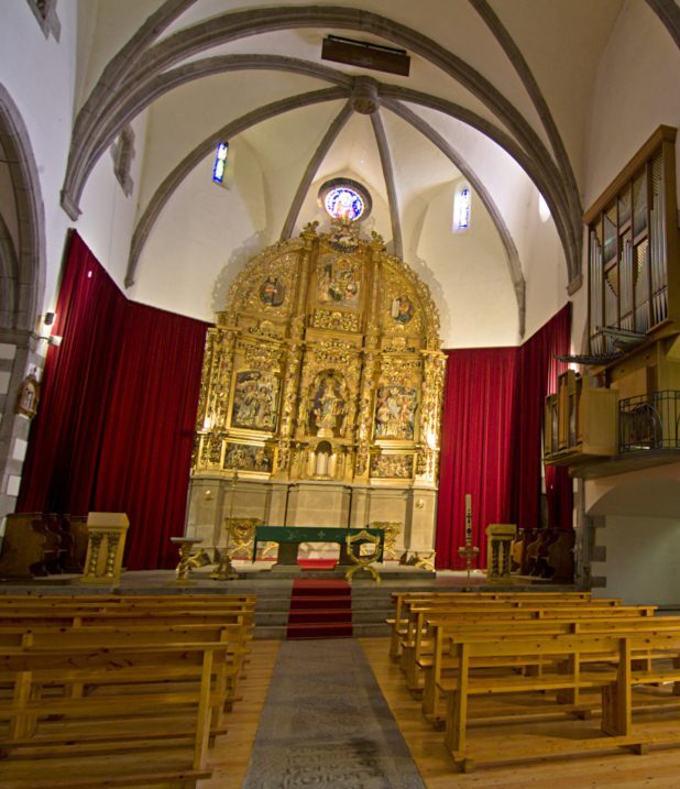 Vista interior de l'església de la Mare de Déu dels Àngels de Llívia amb el retaule barroc que presideix l'església.